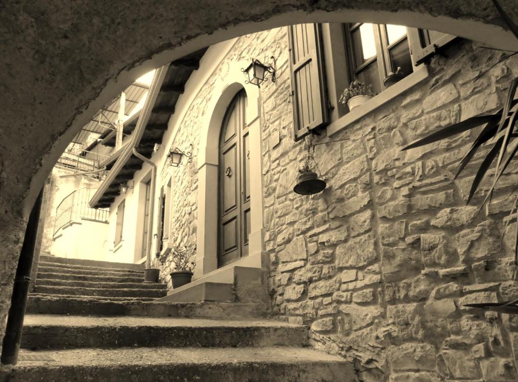a stone building with stairs leading up to a door at Agriturismo Profumo Di Natura in Fivizzano