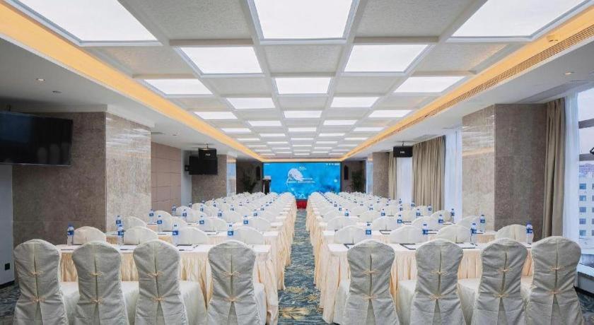 a large banquet hall with white tables and chairs at hailihotel in Dongguan