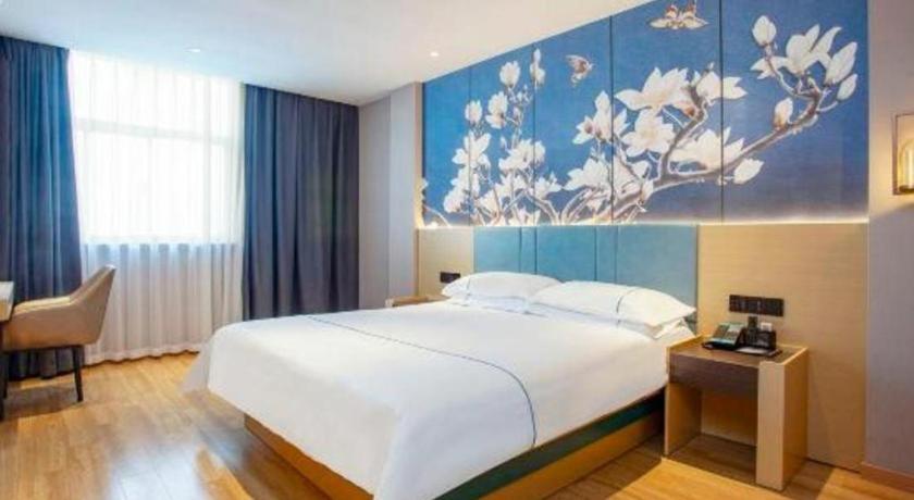 Ένα ή περισσότερα κρεβάτια σε δωμάτιο στο Jinjiang Inn Yangzhou Passenger East Terminal