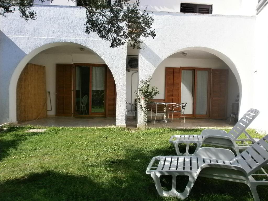 a patio with two chairs and a table in a yard at KATY&MLADEN in Baška