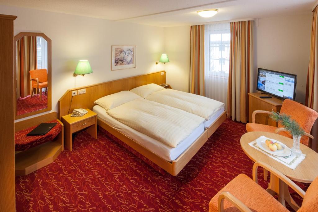 Postel nebo postele na pokoji v ubytování Hotel Cheminee