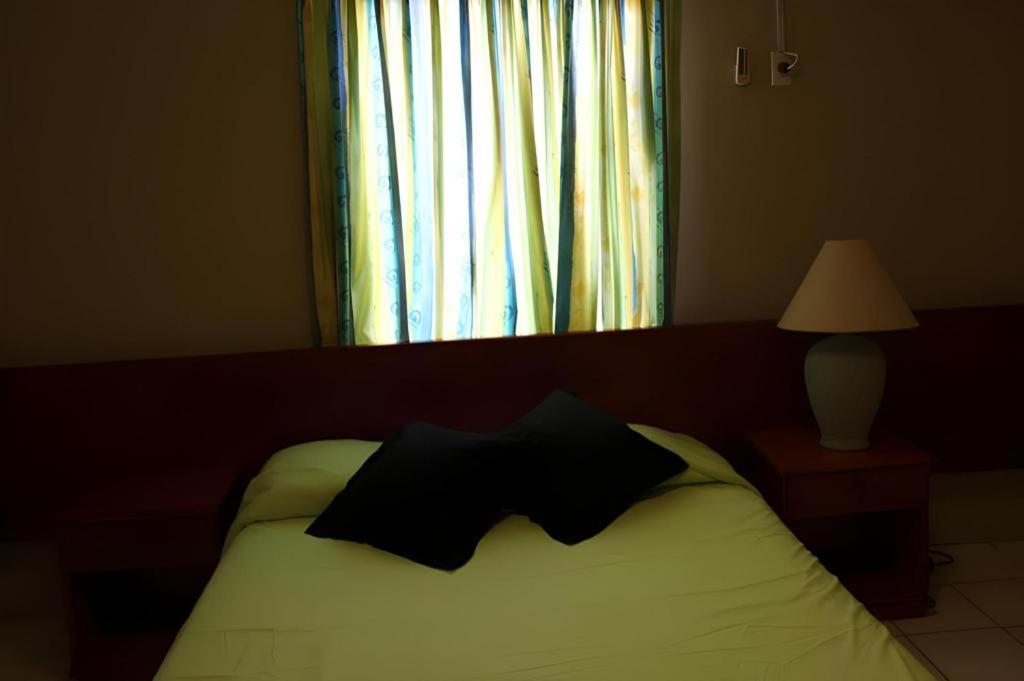 Postel nebo postele na pokoji v ubytování Curacao Lodge
