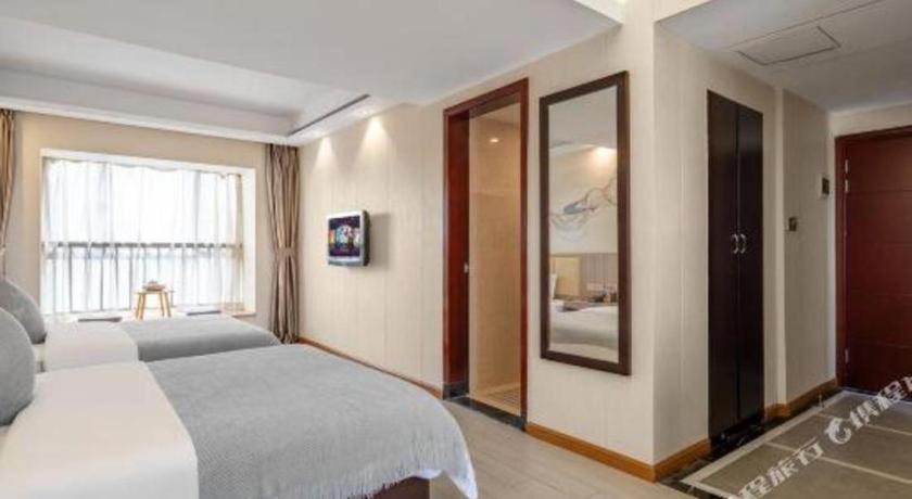 Postel nebo postele na pokoji v ubytování Oriental Hotel