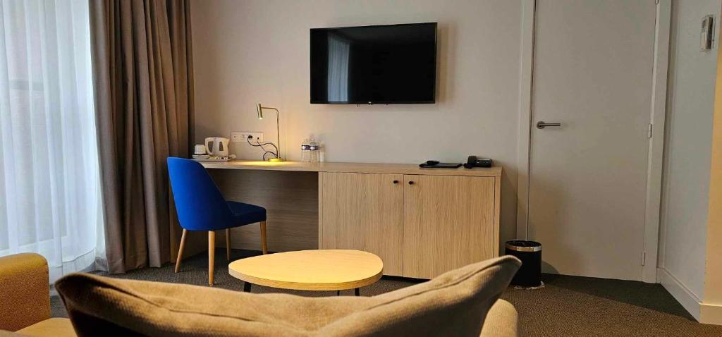 TV a/nebo společenská místnost v ubytování Hotel Les 3 Cles