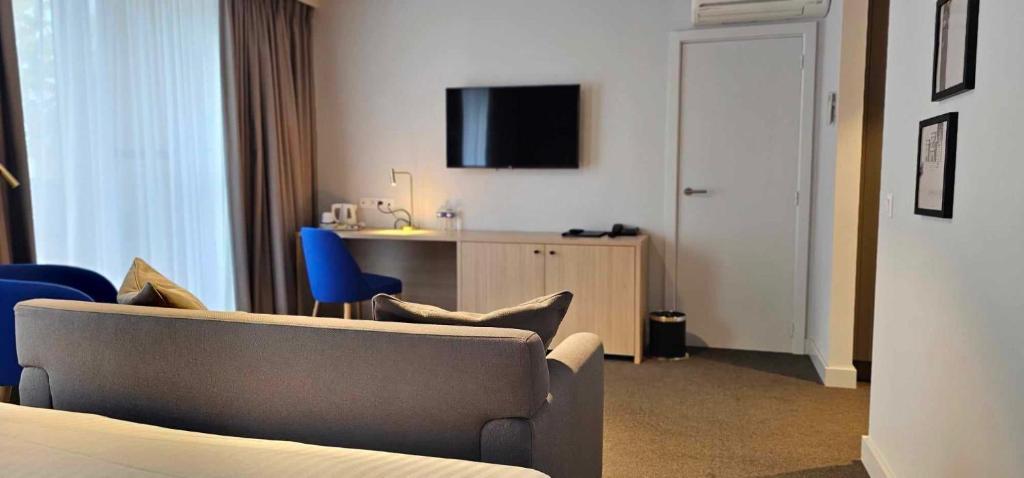 TV a/nebo společenská místnost v ubytování Hotel Les 3 Cles