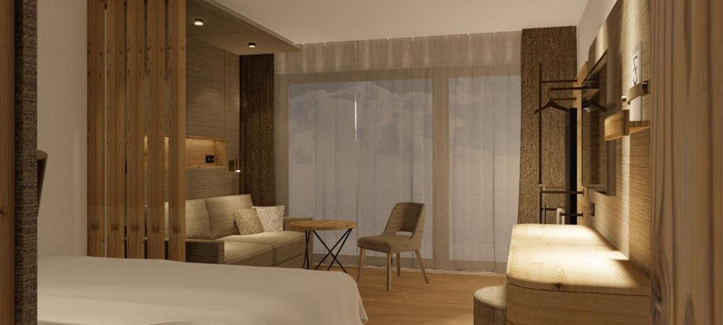 A bed or beds in a room at Hotel Zauchenseehof