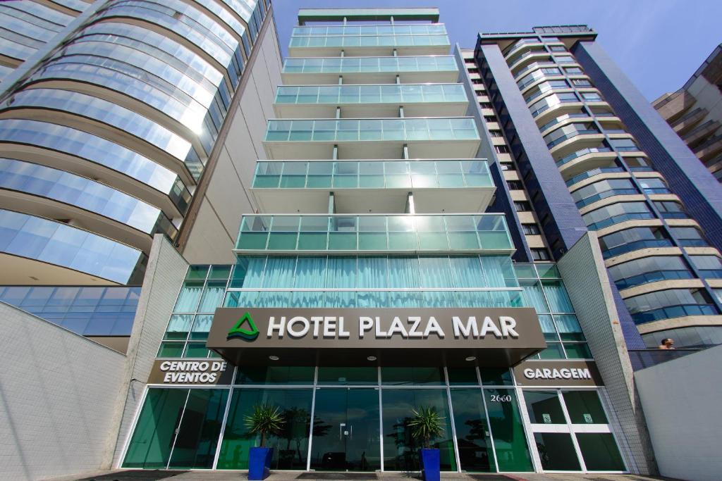 a building with a hotel plaza market sign in front of it at Hotel Plaza Mar in Vila Velha