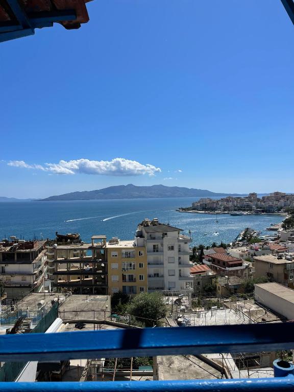 a view of a city with the ocean and buildings at Hotel Gjika in Sarandë