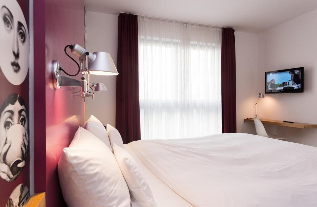 Postel nebo postele na pokoji v ubytování Grimms Hotel Hanau