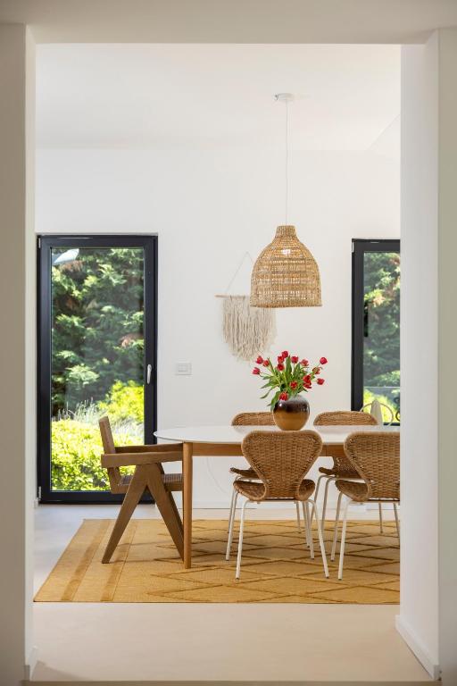 a dining room with a table and chairs at Villa Carla house with hot tub and beautiful garden in Ičići