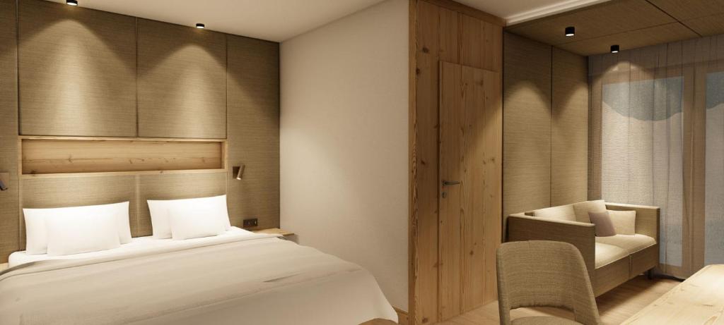 A bed or beds in a room at Hotel Zauchenseehof