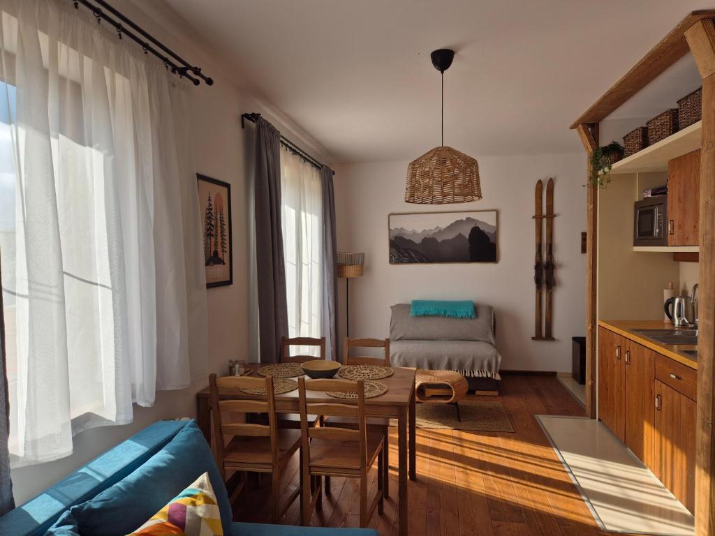 a living room with a table and a couch at High Tatras Apartment J303 in Veľká Lomnica