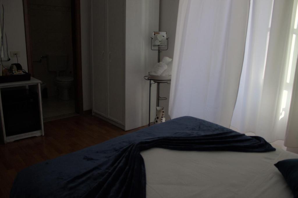 Posteľ alebo postele v izbe v ubytovaní Soggiorno Madrid