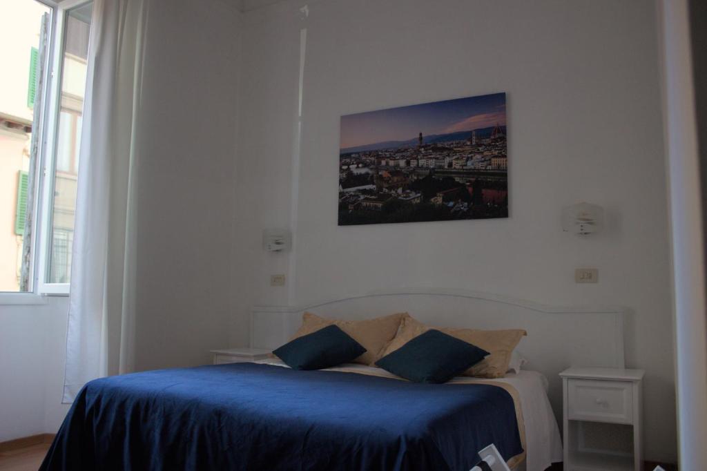 Posteľ alebo postele v izbe v ubytovaní Soggiorno Madrid