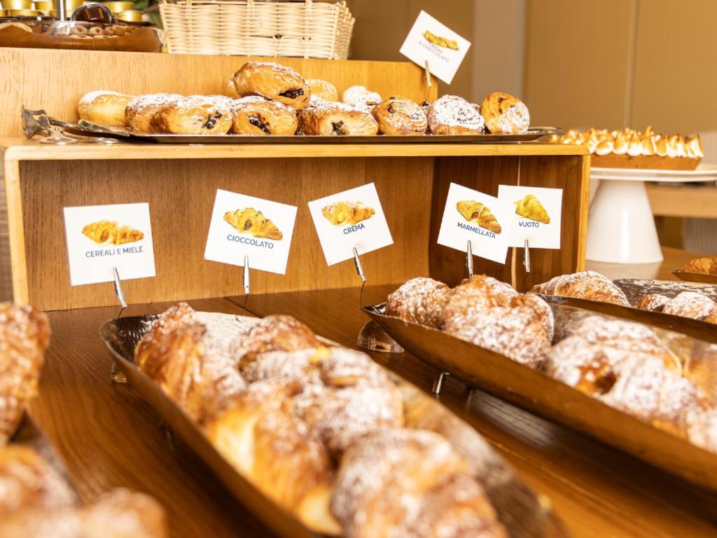 a display of pastries and breads in trays in a bakery at Hotel Cristallo in Giulianova