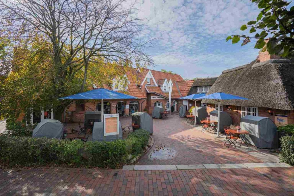 a group of buildings with umbrellas and tables at Wohnung 5 ID 103 in Böhl