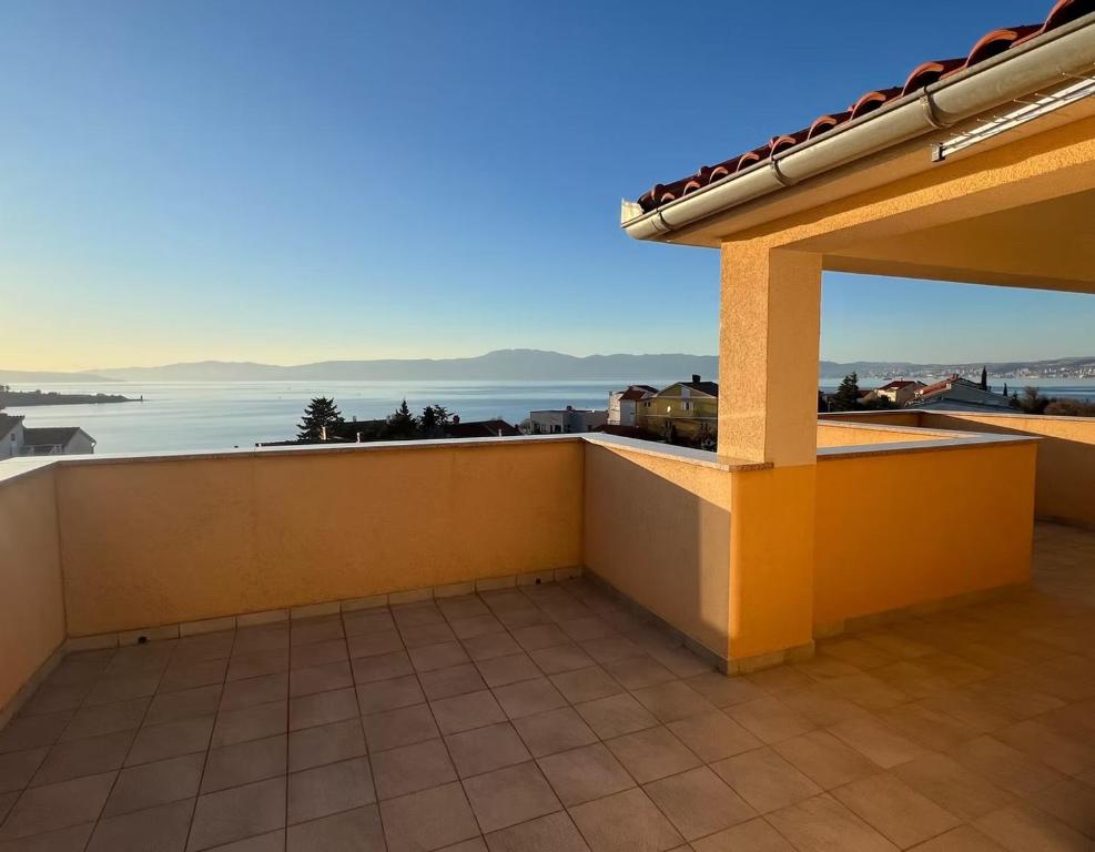 a balcony of a house with a view of the water at Villa Sbay in Omišalj