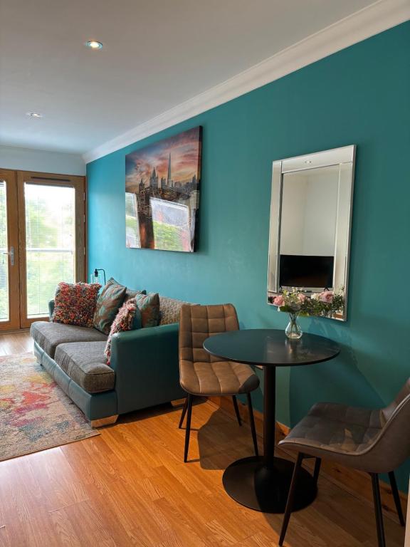 a living room with a couch and a table at Apt 7 Cathedral & River view in Norwich