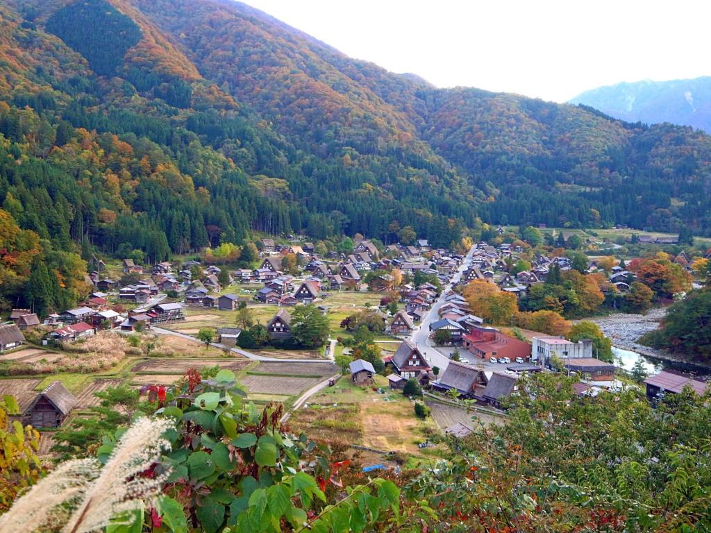 an aerial view of a small town in the mountains at Minshuku Kanjiya in Shirakawa