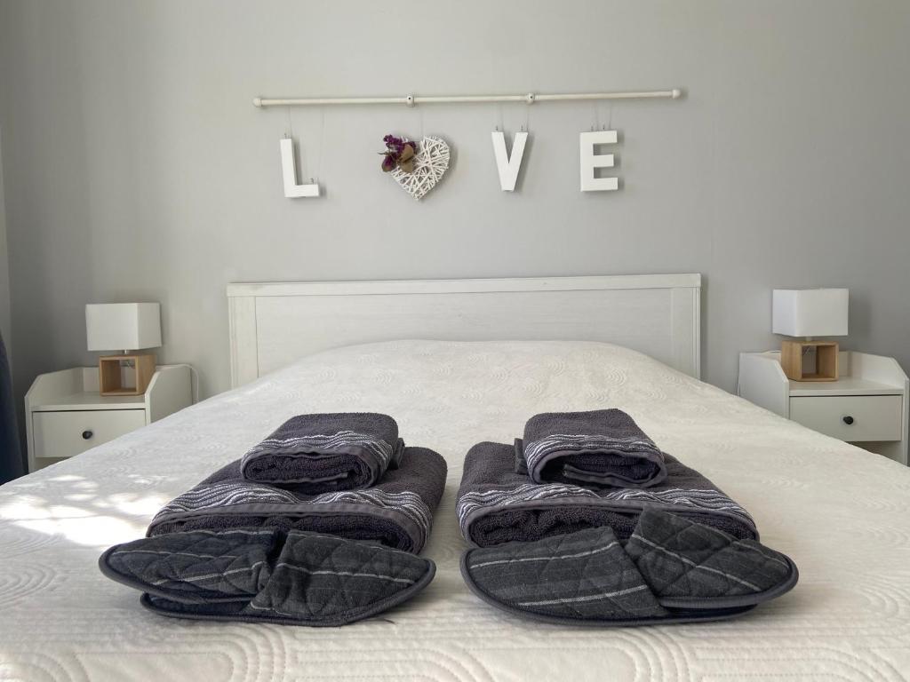 a bedroom with a bed with two towels on it at Sweet Home - 55m2 appartment, garden, swimming pool, parking in Toulouse