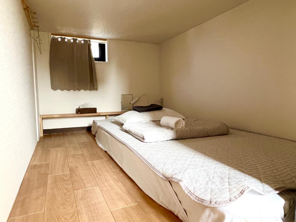 Postel nebo postele na pokoji v ubytování stay papiyon 博多