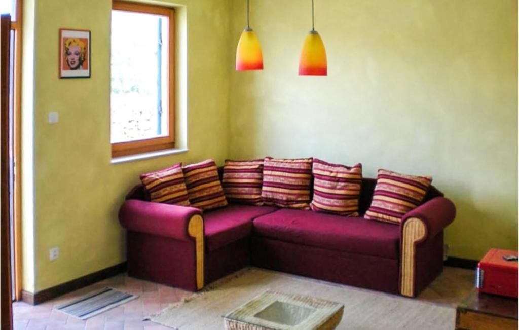 a purple couch in a room with a window at 1 Bedroom Lovely Apartment In Nerezine in Nerezine