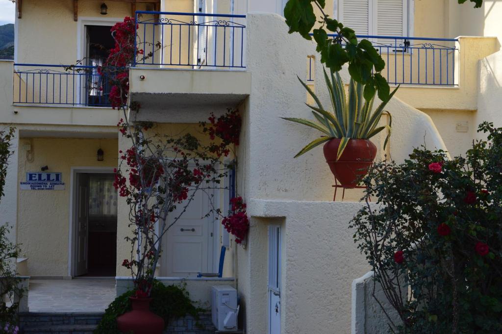 a building with potted plants on the side of it at Elli Studios & Apartments in Marathokampos