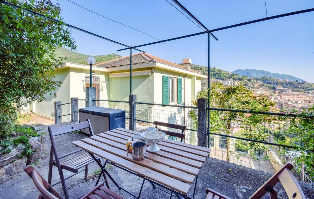 a wooden table and chairs on the balcony of a house at Nice Apartment In Recco With Wifi in Recco
