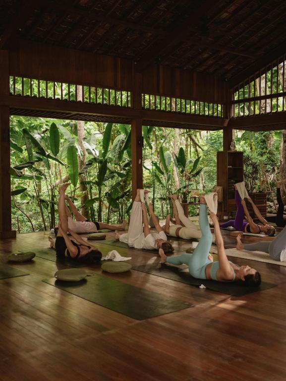 a group of people doing yoga in a room at Grün Resort Uluwatu in Uluwatu