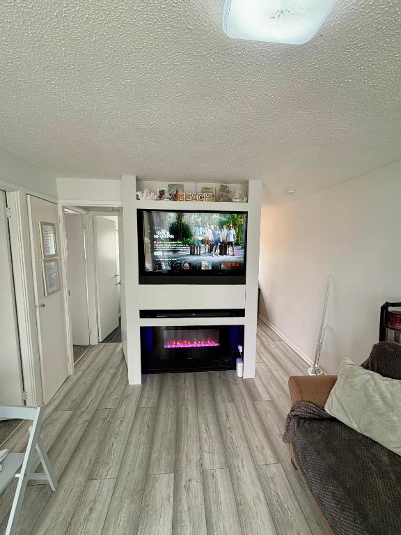 a living room with a flat screen tv on a wall at Norfolk Nest 2 bedroom chalet new media wall in Hemsby