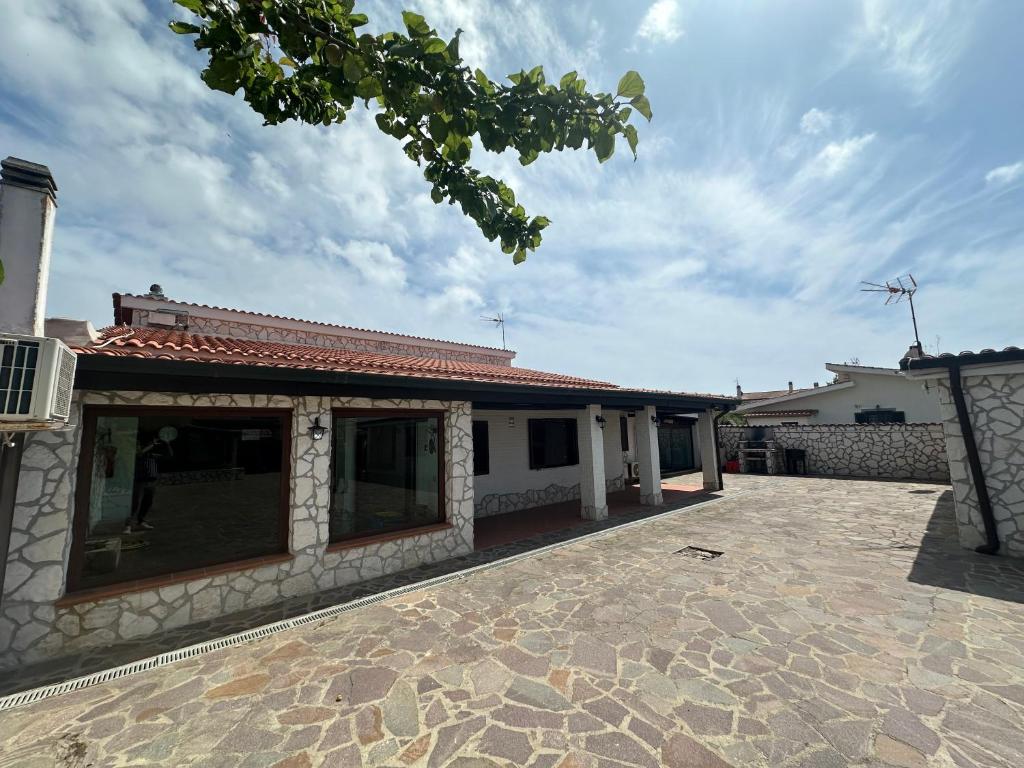 a house with a patio and a windmill in the background at Villa Lelli 1 in Rome