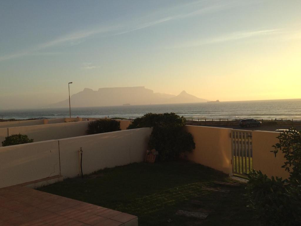a view of the ocean from the balcony of a house at Blouberg Beachfront Apartment - Loadshedding free in Bloubergstrand