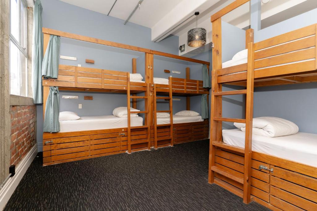 a bunk room with four bunk beds in it at Haka House Auckland K'Road in Auckland
