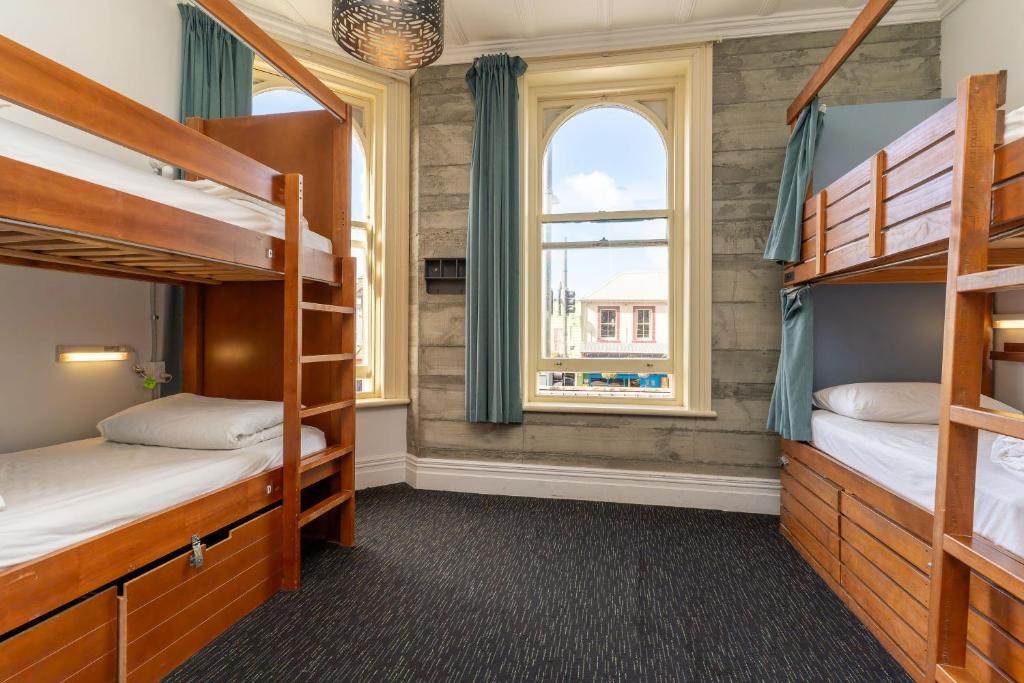 a bedroom with bunk beds and a window at Haka House Auckland K'Road in Auckland