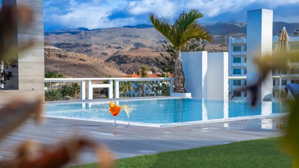 a bird standing in front of a swimming pool at Labranda Marieta & Spa - Adults Only in Playa del Ingles