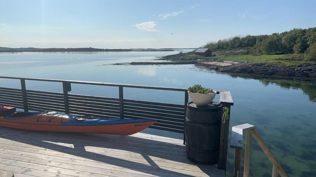 a boat next to a trash can next to a body of water at Cozy townhouse at the sea! in Salhus