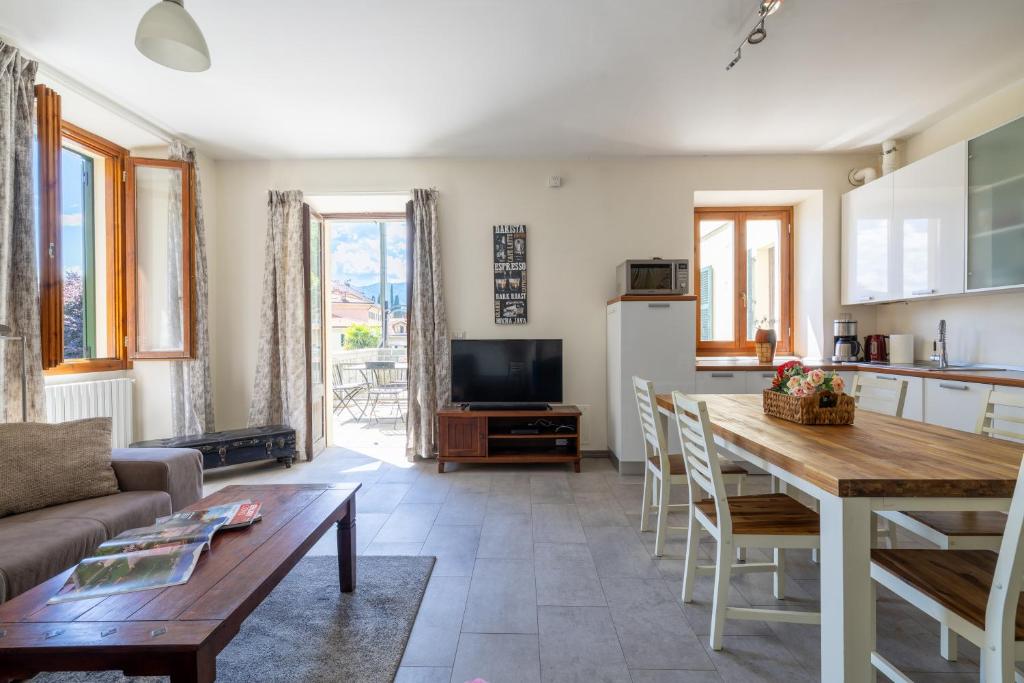 a kitchen and living room with a table and a couch at Apartment Katia - Menaggio in Menaggio