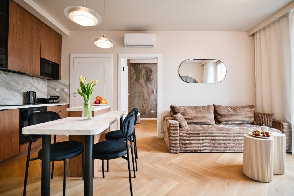 a kitchen and living room with a table and chairs at Jasmine Grand 7 by Housine in Zator