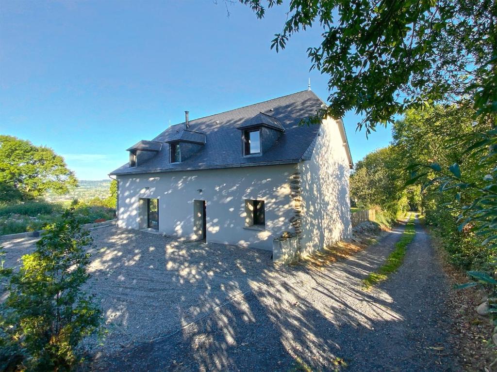 a white house with a pathway leading up to it at Grange Bernata, havre de paix sur la colline in Pontacq