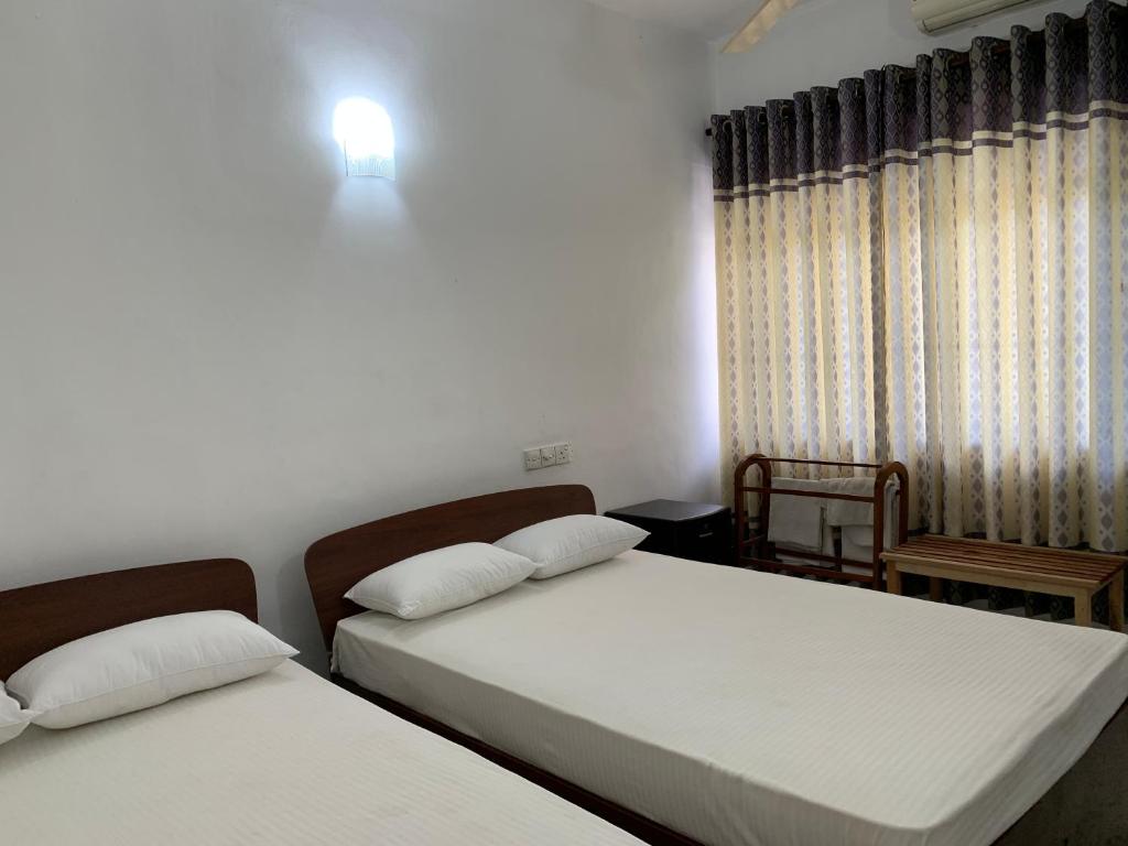 Postel nebo postele na pokoji v ubytování Hotel Ameliya