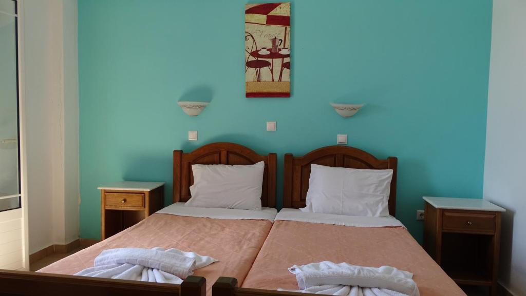 A bed or beds in a room at Hermes-Ios Rooms To Let