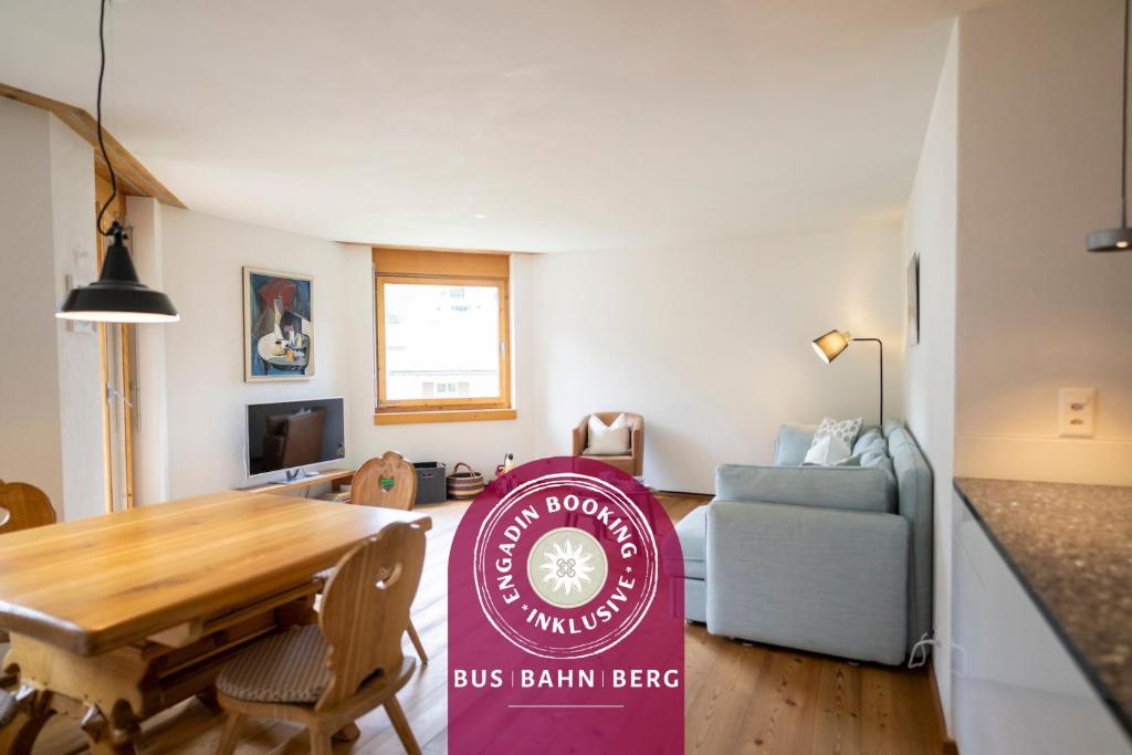 a dining room with a bus barn beef sign in a living room at Chasa Serras Kuemin in Scuol