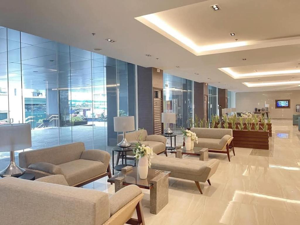 a lobby with couches and tables in a building at City Serenity Escape in Manila