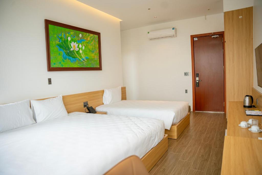Postel nebo postele na pokoji v ubytování Min Min Hotel