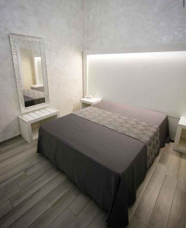 Postel nebo postele na pokoji v ubytování Hotel Paladini