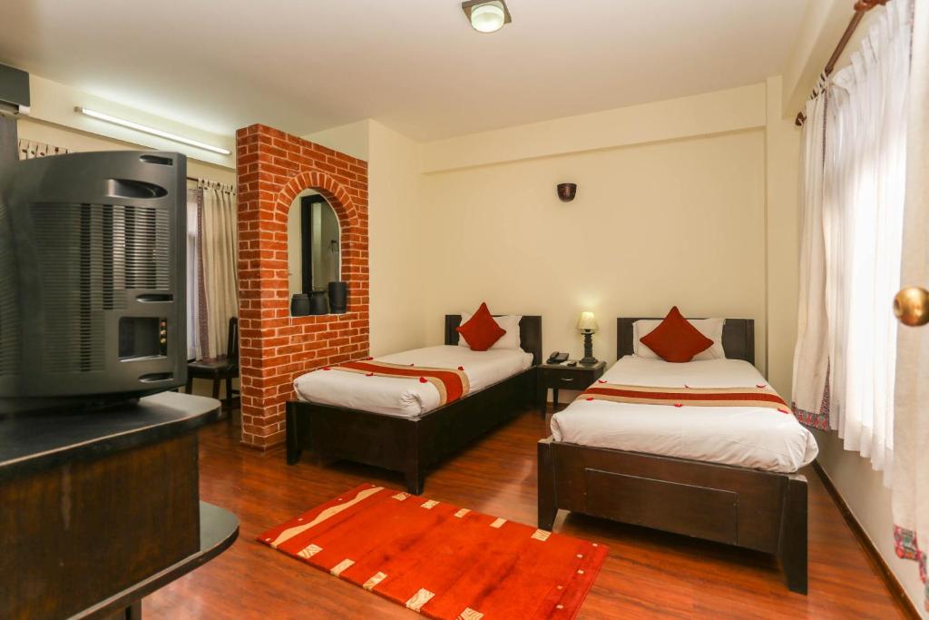Postel nebo postele na pokoji v ubytování Thamel Eco Resort