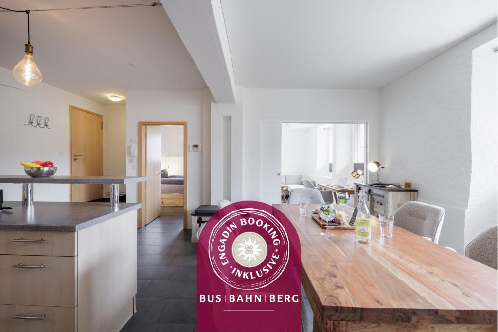 a kitchen with a bus barn beef sign on a wooden table at Chasa Plazzetta in Scuol