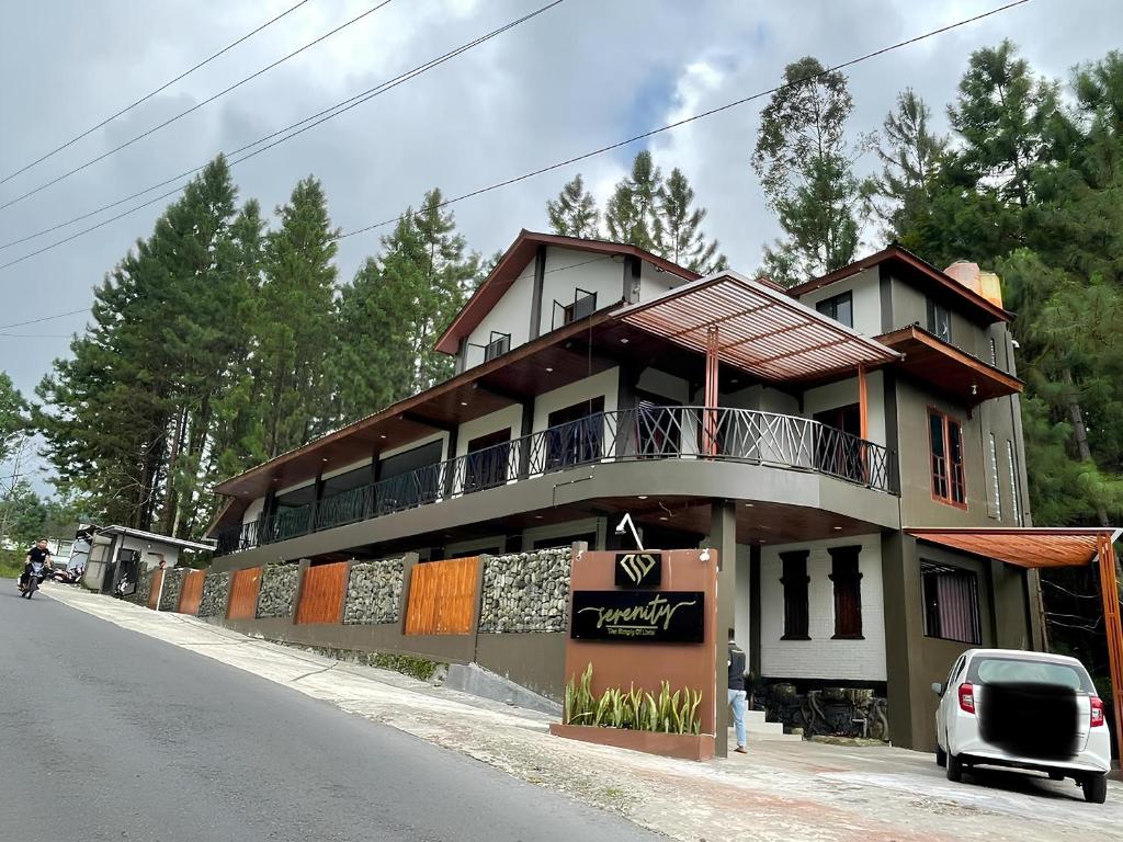 a building with a balcony on the side of a street at Serenity Villa Guci in Tuwel