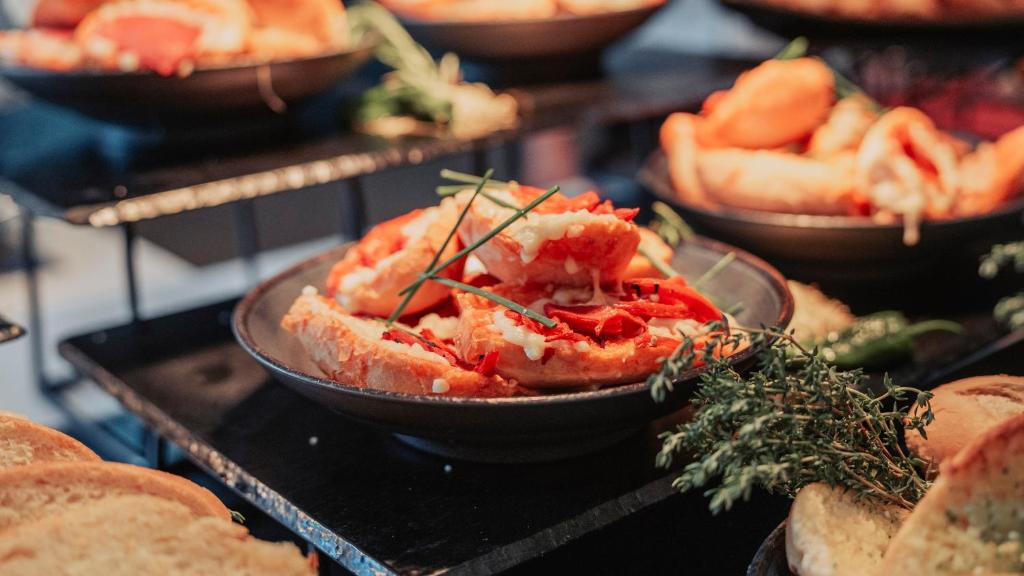 a table topped with bowls of food with bread at Labranda Marieta & Spa - Adults Only in Playa del Ingles