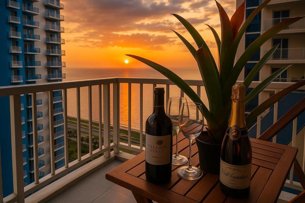 two bottles of wine sitting on a table on a balcony at Elegant 1BR near Solaire, Okada, Mall of Asia in Manila